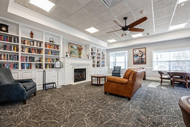 174 Spring Dr Unit 174, East Meadow, NY 11554 - living area with a tray ceiling, built in features, carpet flooring, crown molding, and a ceiling fan