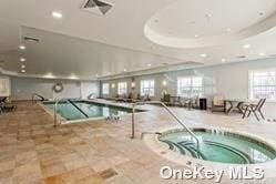 174 Spring Dr Unit 174, East Meadow, NY 11554 - indoor pool with a hot tub