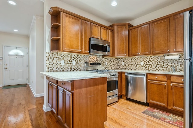 174 Spring Dr Unit 174, East Meadow, NY 11554 - kitchen with appliances with stainless steel finishes, brown cabinetry, open shelves, ornamental molding, and light wood-style floors