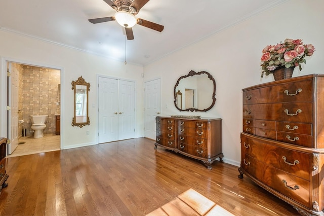 174 Spring Dr Unit 174, East Meadow, NY 11554 - bedroom featuring wood finished floors, ornamental molding, ensuite bath, ceiling fan, and baseboards