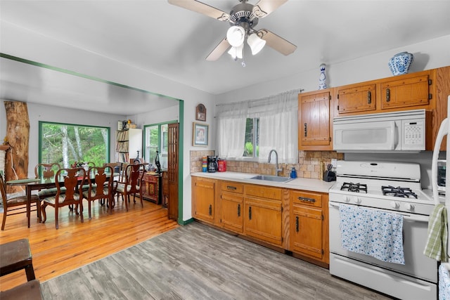 11 Waldweg Dr, Sparrowbush, NY 12780 - kitchen with white appliances, a sink, light countertops, light wood-style floors, and ceiling fan