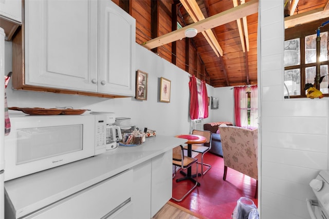 11 Waldweg Dr, Sparrowbush, NY 12780 - kitchen with white microwave, wooden ceiling, white cabinetry, light countertops, and light wood-type flooring