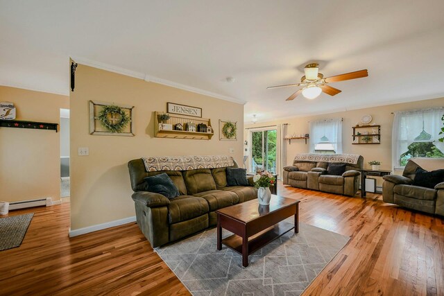 370 Pheasant Pl, Greenport, NY 11944 - living room with a baseboard heating unit, ceiling fan, wood finished floors, crown molding, and baseboards