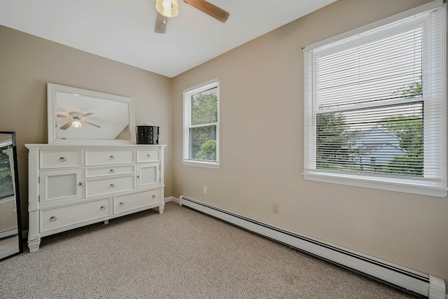 370 Pheasant Pl, Greenport, NY 11944 - unfurnished bedroom with a baseboard radiator, light carpet, ceiling fan, and baseboards