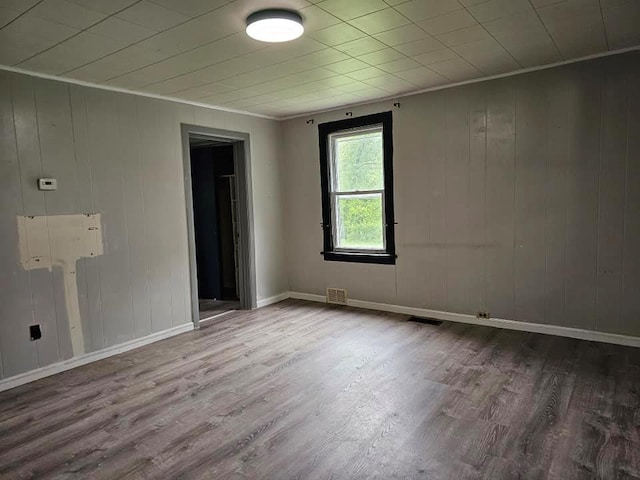 3 Fall St, Port Jervis, NY 12771 - spare room featuring wood finished floors, ornamental molding, baseboards, and wood walls