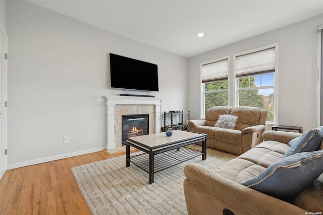 55 Hamptons Court Dr E Unit 55, Eastport, NY 11941 - living room with baseboards, light wood-style floors, a glass covered fireplace, and recessed lighting
