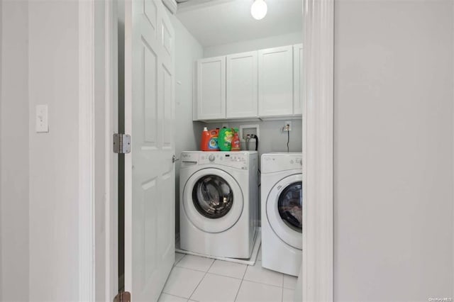 55 Hamptons Court Dr E Unit 55, Eastport, NY 11941 - laundry room featuring washer and dryer, cabinet space, and light tile patterned flooring