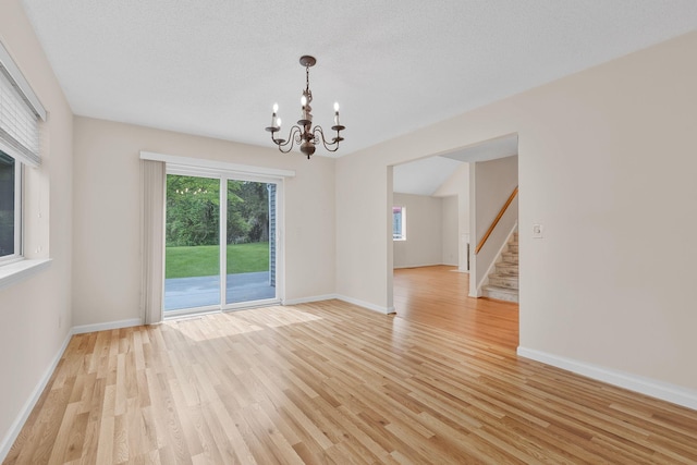19 Cushing Grn S, Pawling, NY 12564 - spare room with a chandelier, light wood-style flooring, stairs, and baseboards