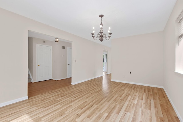 19 Cushing Grn S, Pawling, NY 12564 - empty room with a chandelier, light wood-style flooring, baseboards, and stairway