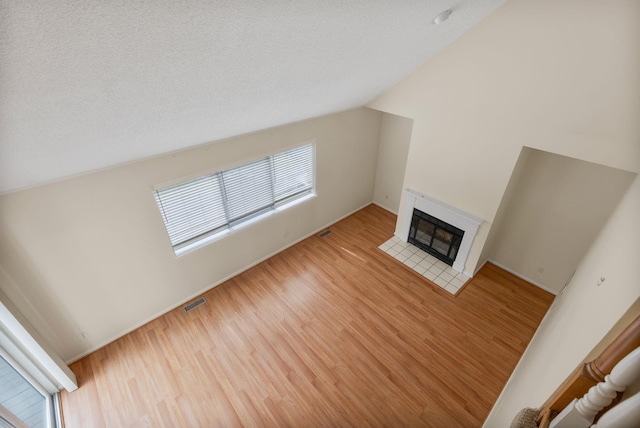19 Cushing Grn S, Pawling, NY 12564 - unfurnished living room with wood finished floors, healthy amount of natural light, a fireplace with flush hearth, baseboards, and lofted ceiling