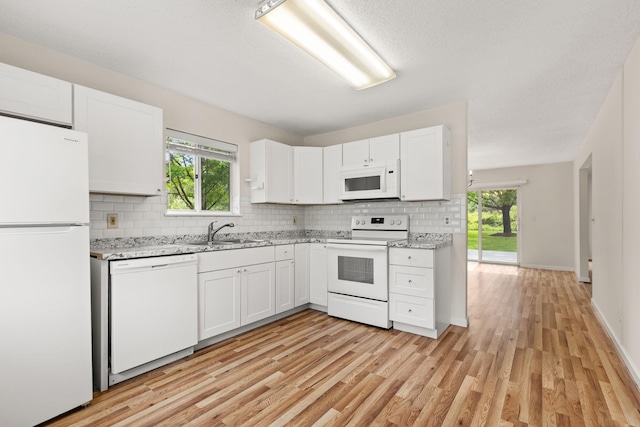 19 Cushing Grn S, Pawling, NY 12564 - kitchen featuring white appliances, a sink, backsplash, light wood-style floors, and white cabinets