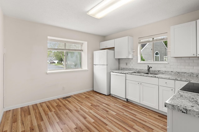 19 Cushing Grn S, Pawling, NY 12564 - kitchen featuring white appliances, a sink, backsplash, light wood-style flooring, and baseboards