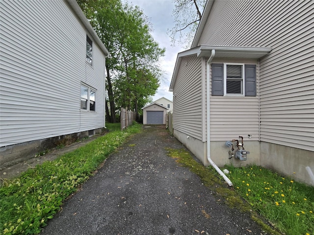 27 Thompson St, Port Jervis, NY 12771 - view of property exterior with driveway, a detached garage, and an outdoor structure