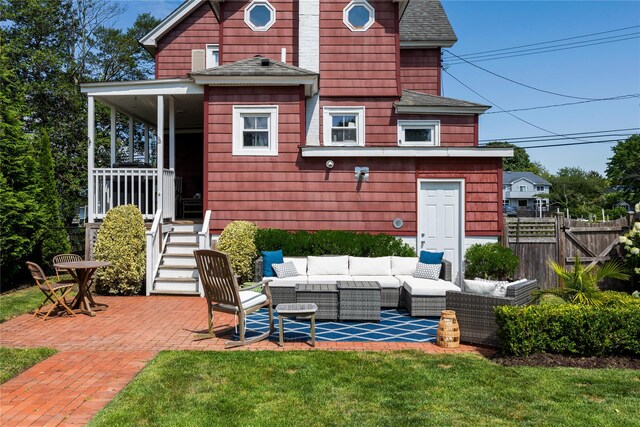 28 Shore Rd, Babylon, NY 11702 - rear view of house featuring an outdoor living space, a shingled roof, and a patio area