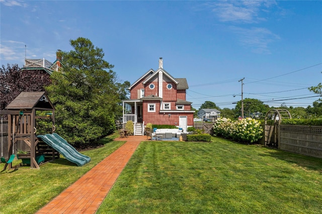 28 Shore Rd, Babylon, NY 11702 - rear view of property featuring an outdoor living space, a playground, and a chimney