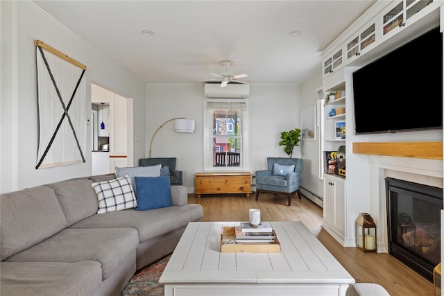 28 Shore Rd, Babylon, NY 11702 - living room featuring a baseboard radiator, light wood-style flooring, a glass covered fireplace, crown molding, and ceiling fan