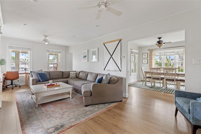 28 Shore Rd, Babylon, NY 11702 - living room featuring a ceiling fan, healthy amount of natural light, wood finished floors, and crown molding