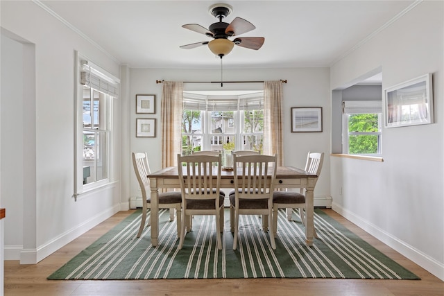 28 Shore Rd, Babylon, NY 11702 - dining room with baseboards, ceiling fan, crown molding, and light wood-style floors