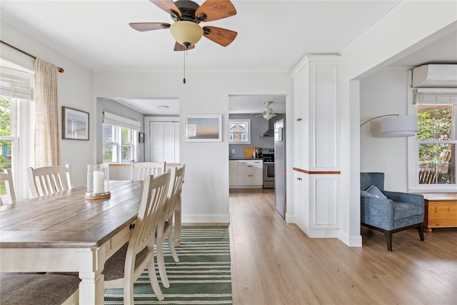 28 Shore Rd, Babylon, NY 11702 - dining space with a ceiling fan, light wood-style floors, baseboards, a wall mounted air conditioner, and ornamental molding