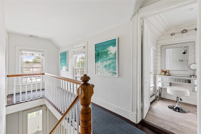 28 Shore Rd, Babylon, NY 11702 - hallway featuring lofted ceiling, an upstairs landing, wood finished floors, and baseboards