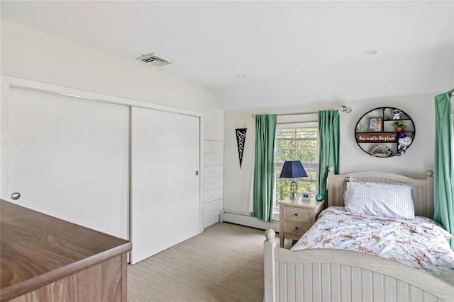 28 Shore Rd, Babylon, NY 11702 - bedroom with a baseboard radiator, light colored carpet, a closet, and vaulted ceiling