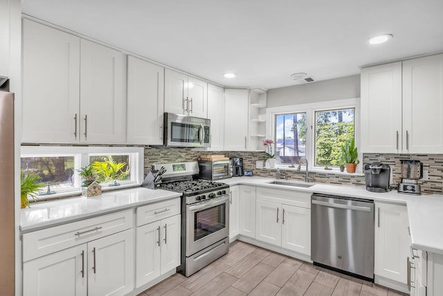 167 Grandview Ave, Nanuet, NY 10954 - kitchen with appliances with stainless steel finishes, decorative backsplash, light countertops, recessed lighting, and white cabinetry