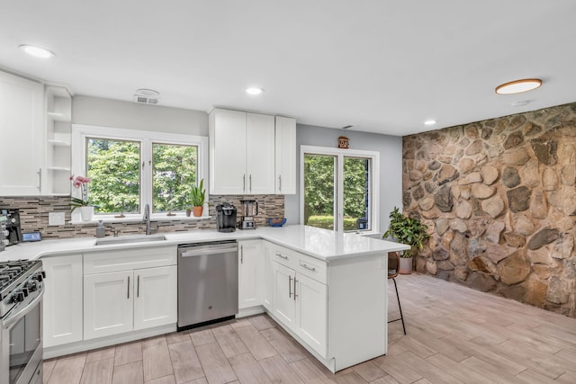 167 Grandview Ave, Nanuet, NY 10954 - kitchen with stainless steel appliances, a peninsula, tasteful backsplash, light countertops, and recessed lighting