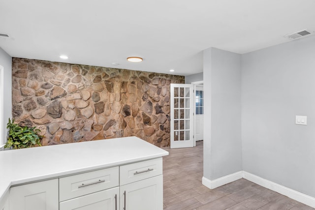 167 Grandview Ave, Nanuet, NY 10954 - kitchen featuring light wood-style floors, white cabinetry, light countertops, a peninsula, and recessed lighting
