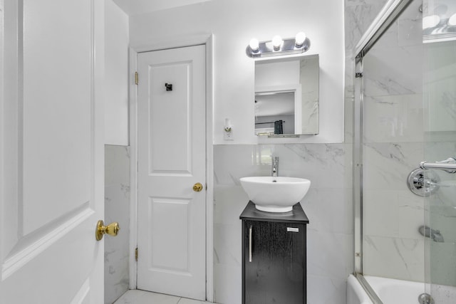 167 Grandview Ave, Nanuet, NY 10954 - bathroom with vanity, combined bath / shower with glass door, and tile walls