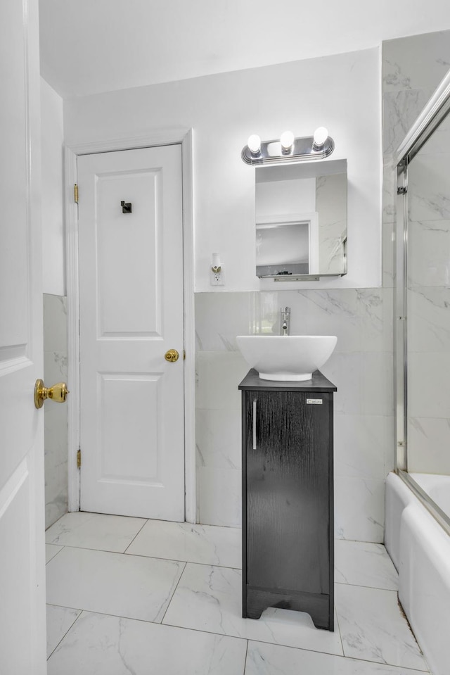 167 Grandview Ave, Nanuet, NY 10954 - bathroom with vanity, marble look tile flooring, and bath / shower combo with glass door