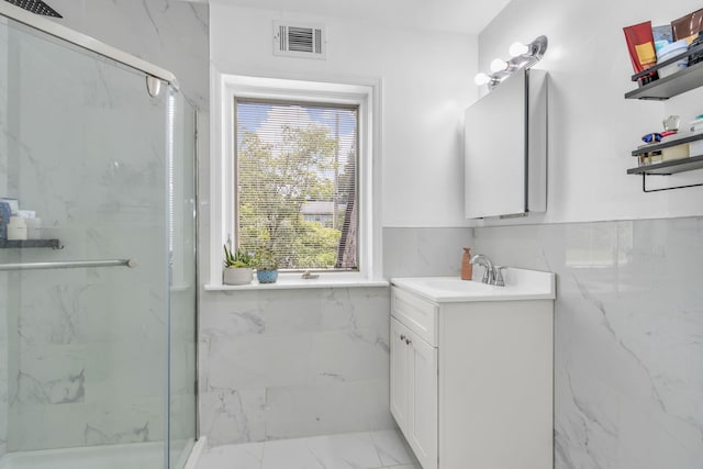 167 Grandview Ave, Nanuet, NY 10954 - bathroom featuring a marble finish shower, marble finish floors, vanity, tile walls, and wainscoting