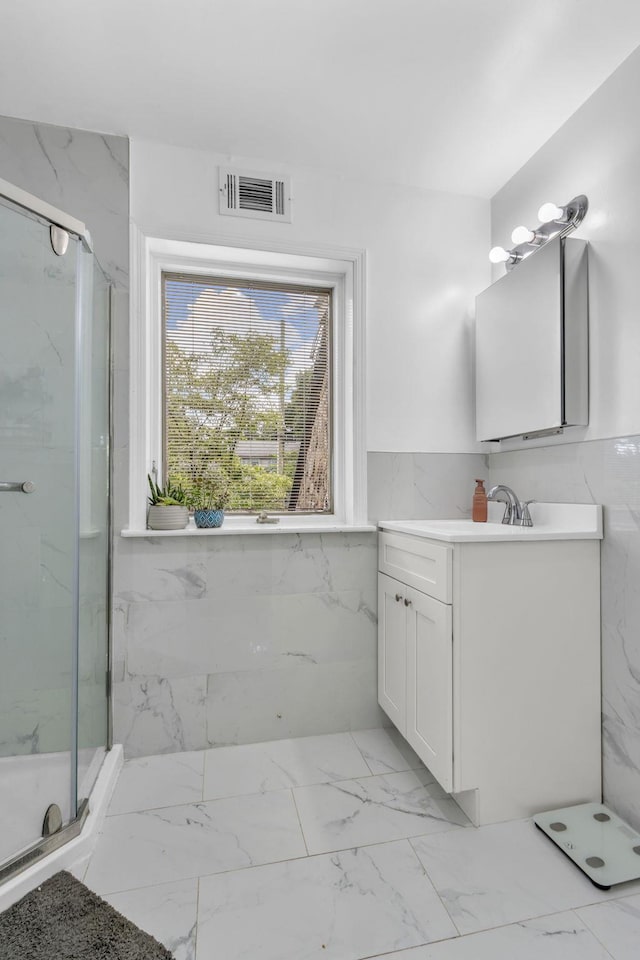 167 Grandview Ave, Nanuet, NY 10954 - bathroom with marble look tiles, vanity, tile walls, a marble finish shower, and wainscoting