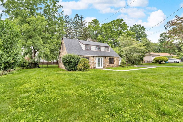 167 Grandview Ave, Nanuet, NY 10954 - view of front of house with stone siding, a chimney, and view of scattered trees