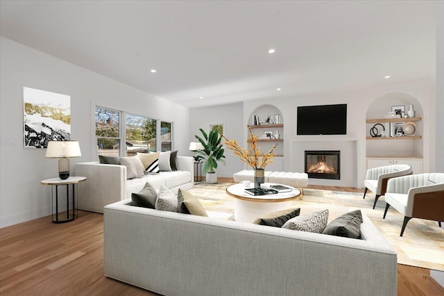 118 Broadway, Massapequa Park, NY 11762 - living area with a glass covered fireplace, built in features, wood finished floors, recessed lighting, and baseboards