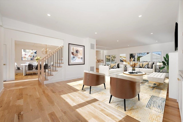 118 Broadway, Massapequa Park, NY 11762 - living room featuring stairway, light wood finished floors, a chandelier, and recessed lighting
