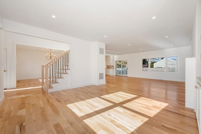 118 Broadway, Massapequa Park, NY 11762 - unfurnished living room featuring a chandelier, light wood-style floors, stairway, recessed lighting, and baseboards