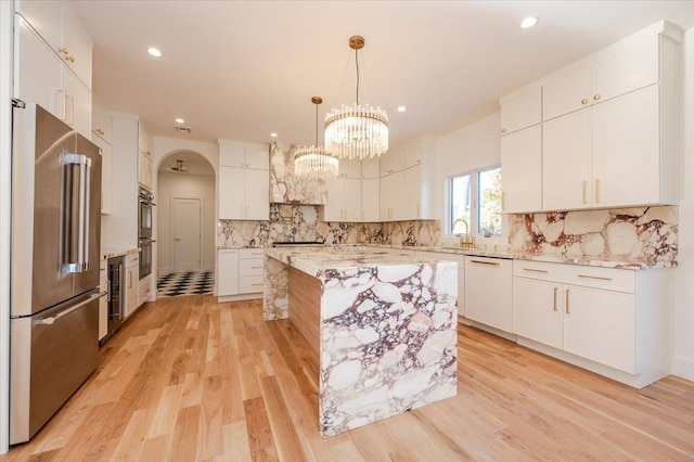 118 Broadway, Massapequa Park, NY 11762 - kitchen featuring stainless steel appliances, light wood finished floors, beverage cooler, recessed lighting, and decorative backsplash