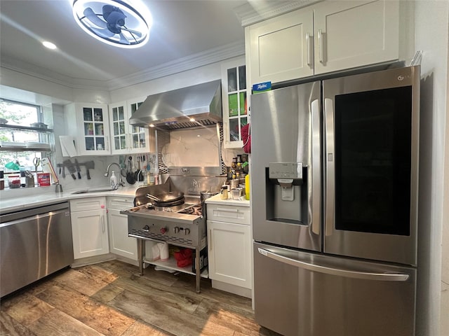 313 88th St, Brooklyn, NY 11209 - kitchen featuring stainless steel appliances, wall chimney range hood, a sink, crown molding, and light countertops