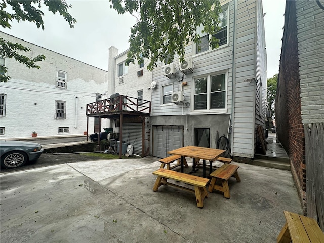 313 88th St, Brooklyn, NY 11209 - back of house featuring an attached garage, driveway, and a patio