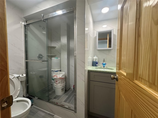 313 88th St, Brooklyn, NY 11209 - bathroom featuring tile walls, vanity, a stall shower, toilet, and tile patterned flooring
