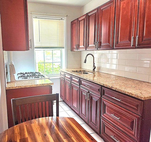 5607 31st Ave Unit 1B, Woodside, NY 11377 - kitchen with a sink, dark brown cabinets, tasteful backsplash, light stone counters, and light tile patterned flooring