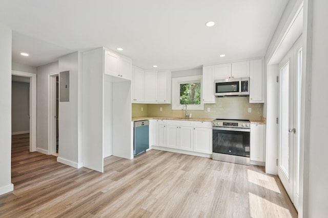 10 De Clark Pl, Nanuet, NY 10954 - kitchen with stainless steel appliances, light wood finished floors, white cabinetry, and recessed lighting
