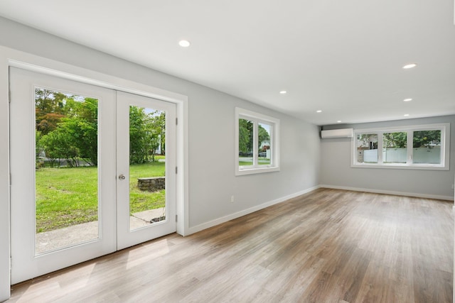10 De Clark Pl, Nanuet, NY 10954 - spare room featuring a wall mounted AC, french doors, wood finished floors, and recessed lighting