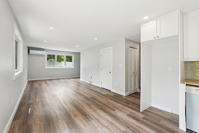 10 De Clark Pl, Nanuet, NY 10954 - unfurnished living room featuring wood finished floors, an AC wall unit, and recessed lighting