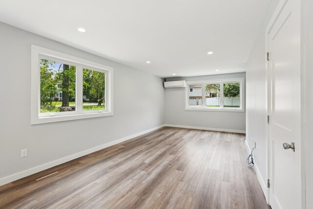 10 De Clark Pl, Nanuet, NY 10954 - unfurnished room with an AC wall unit, wood finished floors, and recessed lighting
