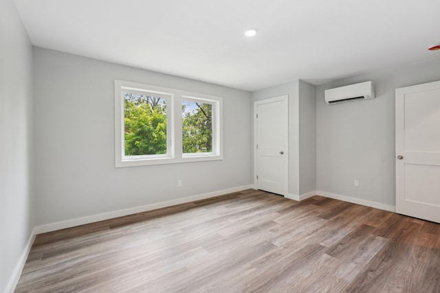 10 De Clark Pl, Nanuet, NY 10954 - unfurnished bedroom with a wall unit AC, wood finished floors, and recessed lighting