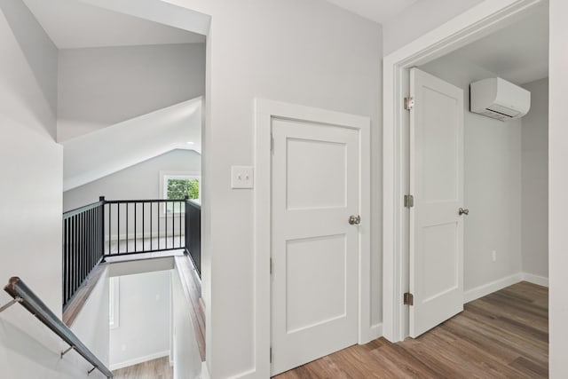 10 De Clark Pl, Nanuet, NY 10954 - stairway with an AC wall unit, wood finished floors, and vaulted ceiling