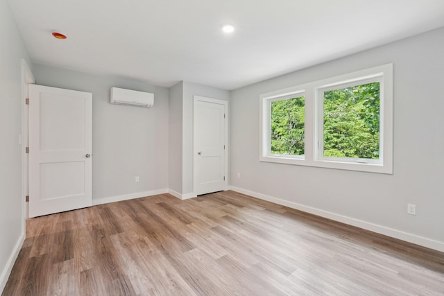 10 De Clark Pl, Nanuet, NY 10954 - unfurnished bedroom with an AC wall unit and light wood finished floors