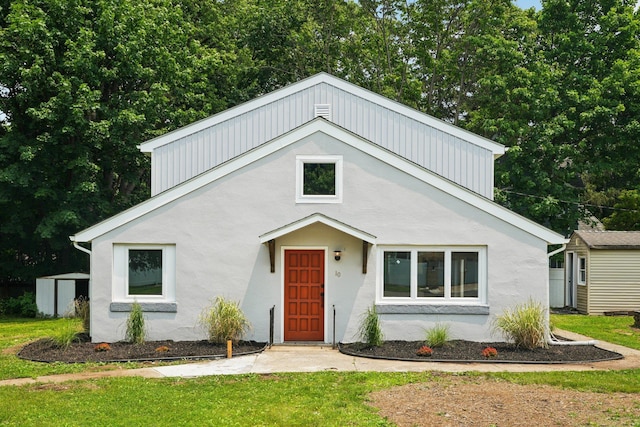 10 De Clark Pl, Nanuet, NY 10954 - view of front of home with a storage unit, a front lawn, and stucco siding