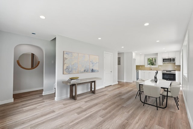 10 De Clark Pl, Nanuet, NY 10954 - kitchen with stainless steel microwave, stove, white cabinetry, light wood-style floors, and recessed lighting